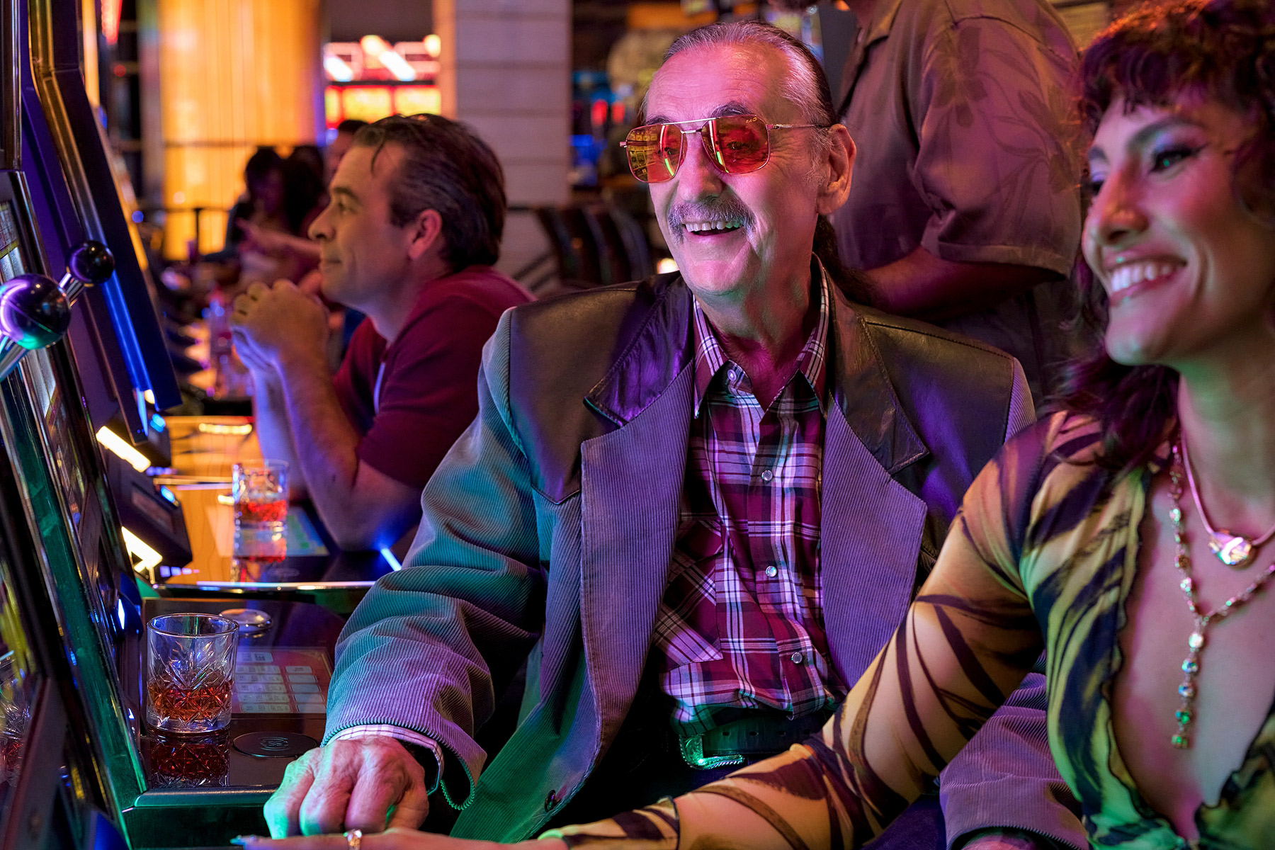 Two people playing slots