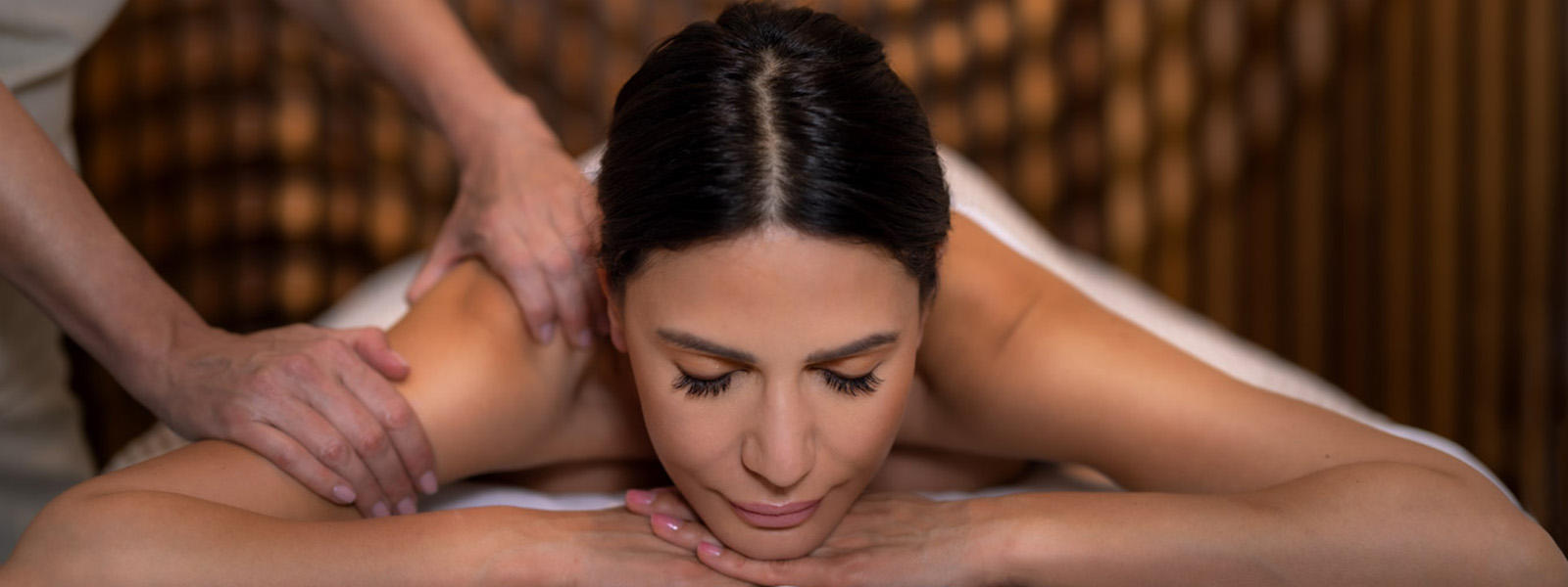 Woman lying down receiving a massage in a spa.