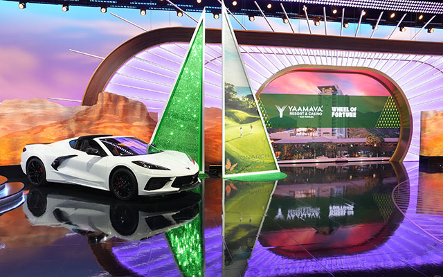Wheel of Fortune casino promotion featuring a white Corvette prize car.